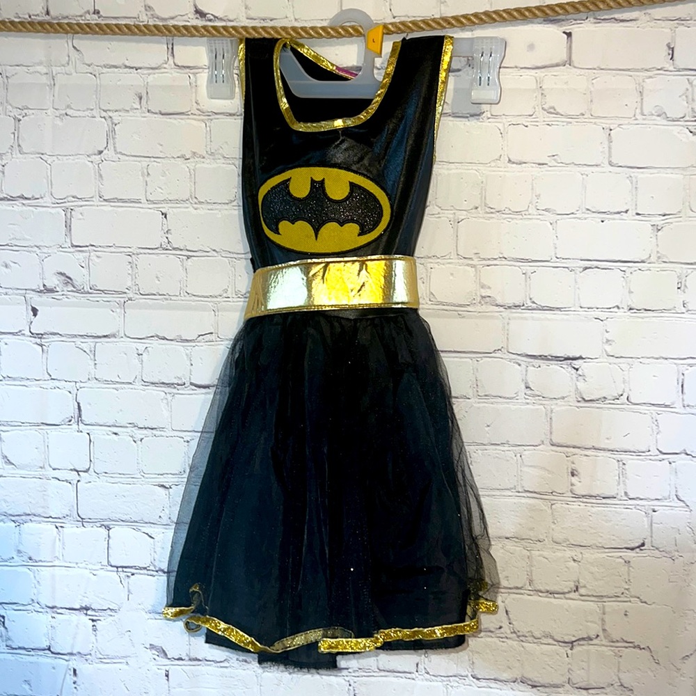Bat Girl black and gold Halloween costume. Comes with mask, arm pieces and belt.